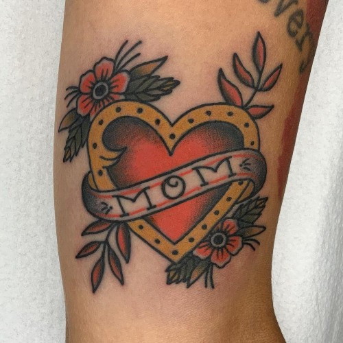 Traditional mom heart tattoo on the arm, a classic men tattoo idea.