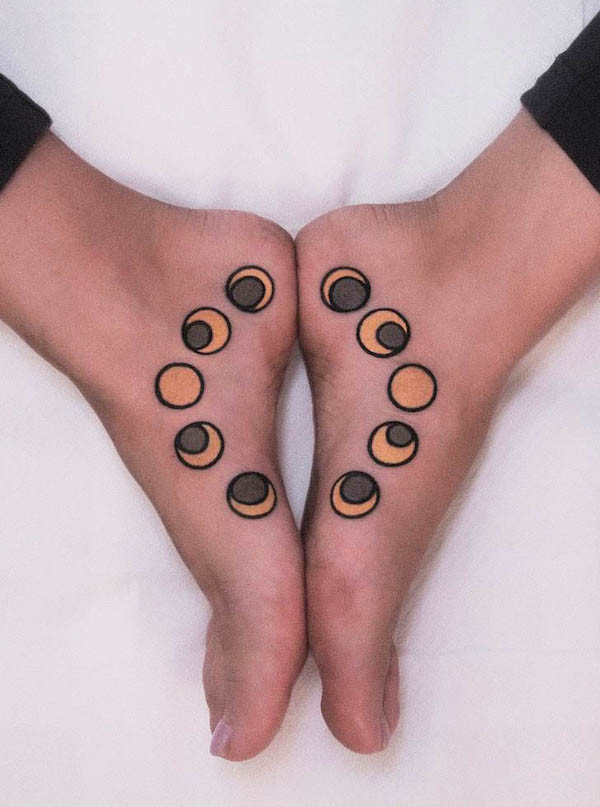 Moon phase foot tattoos in contrasting colors, a matching design with a unique visual appeal