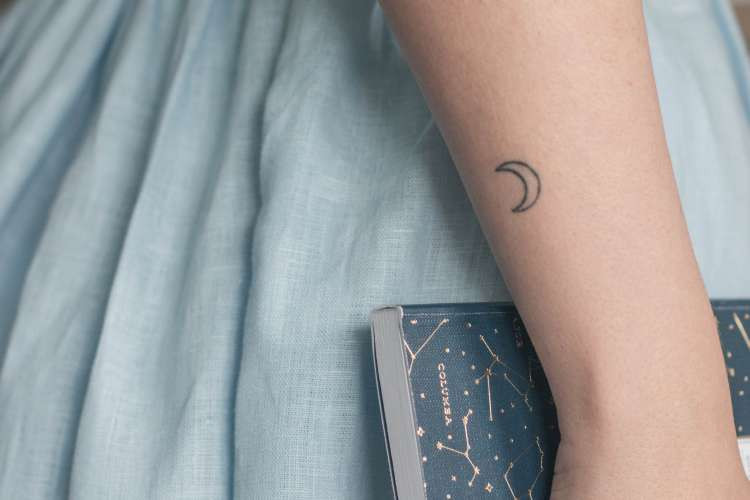 mini moon tattoo on arm