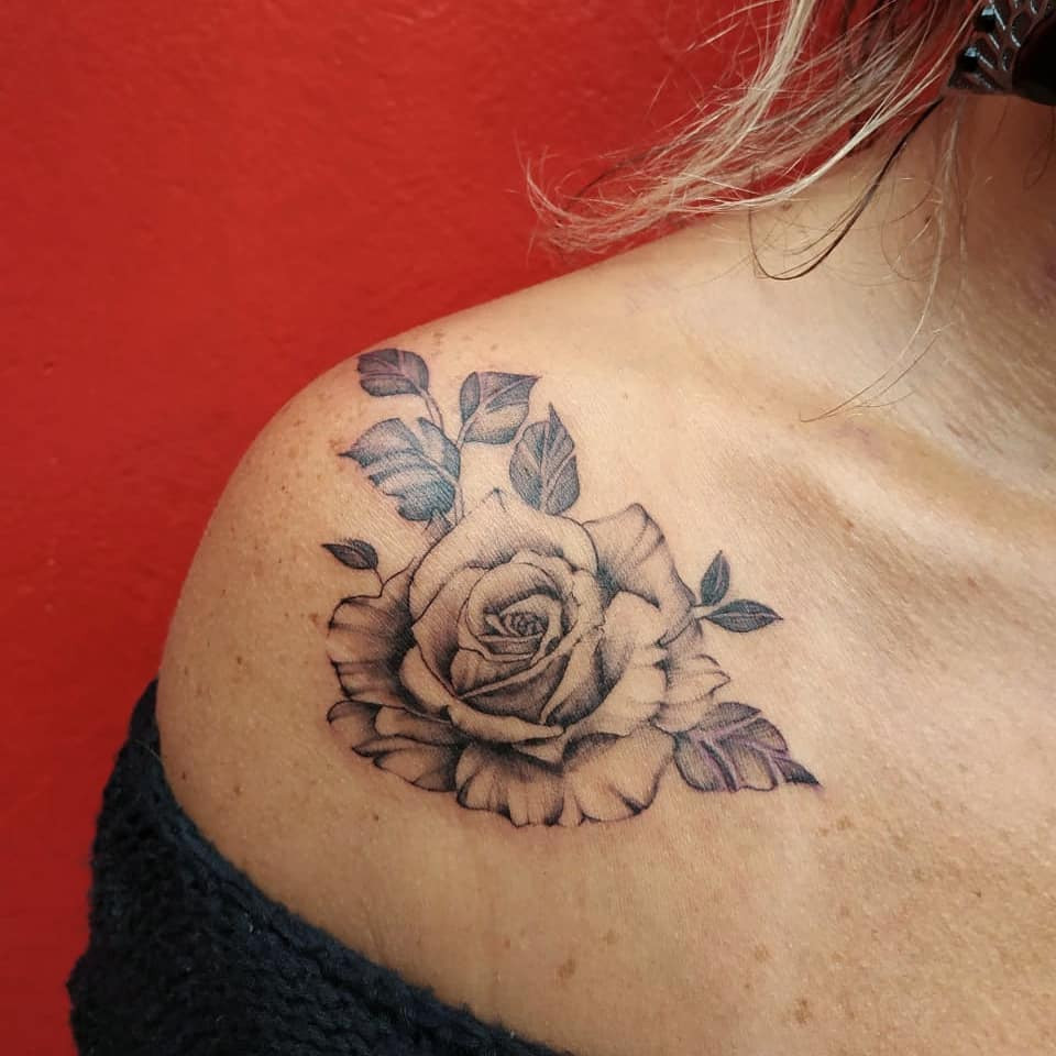 Shaded rose tattoo on arm, realistic and detailed rose design