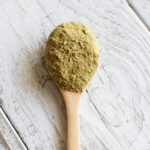 Close-up of henna powder in a bowl, an essential ingredient for natural henna tattoo paste.