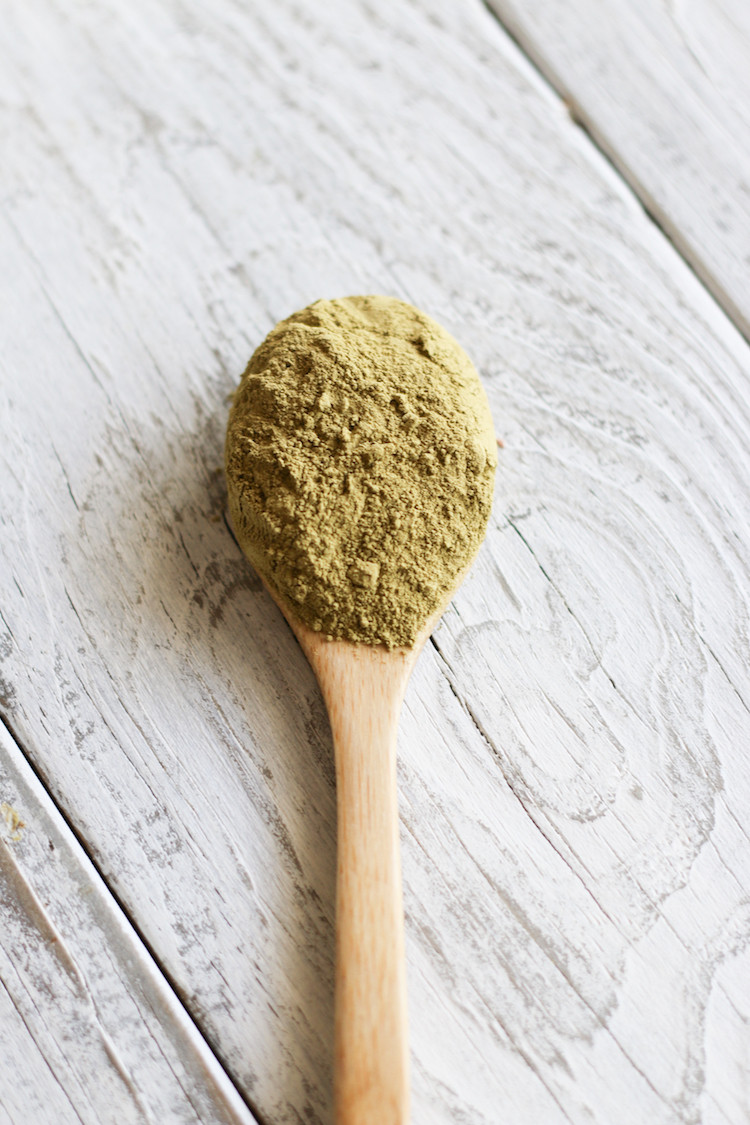 Close-up of henna powder in a bowl, an essential ingredient for natural henna tattoo paste.