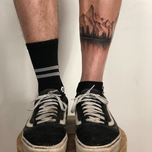 Botanical floral tattoo on a man's leg