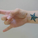 Nautical star tattoo on a wrist