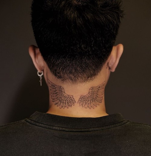 Bold angel neck tattoo with wings, making a visible statement of freedom, power, and personal symbolism.