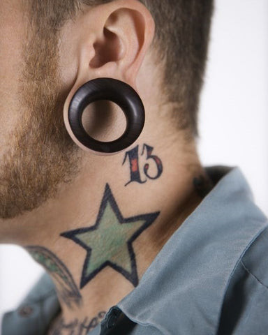 Star neck tattoo men featuring a singular prominent star