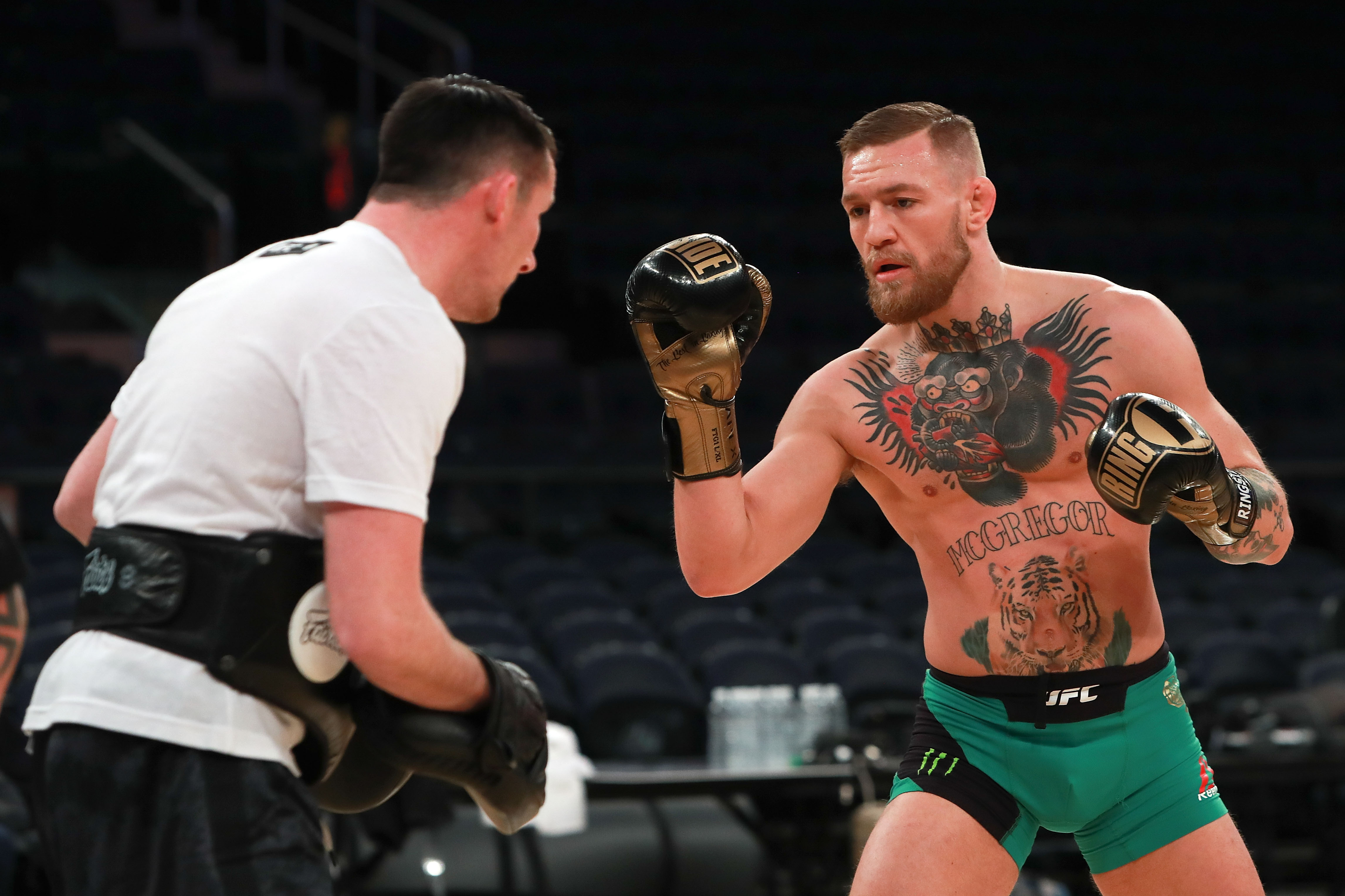 Conor McGregor's abdomen tattoo featuring a tiger and his name with nickname