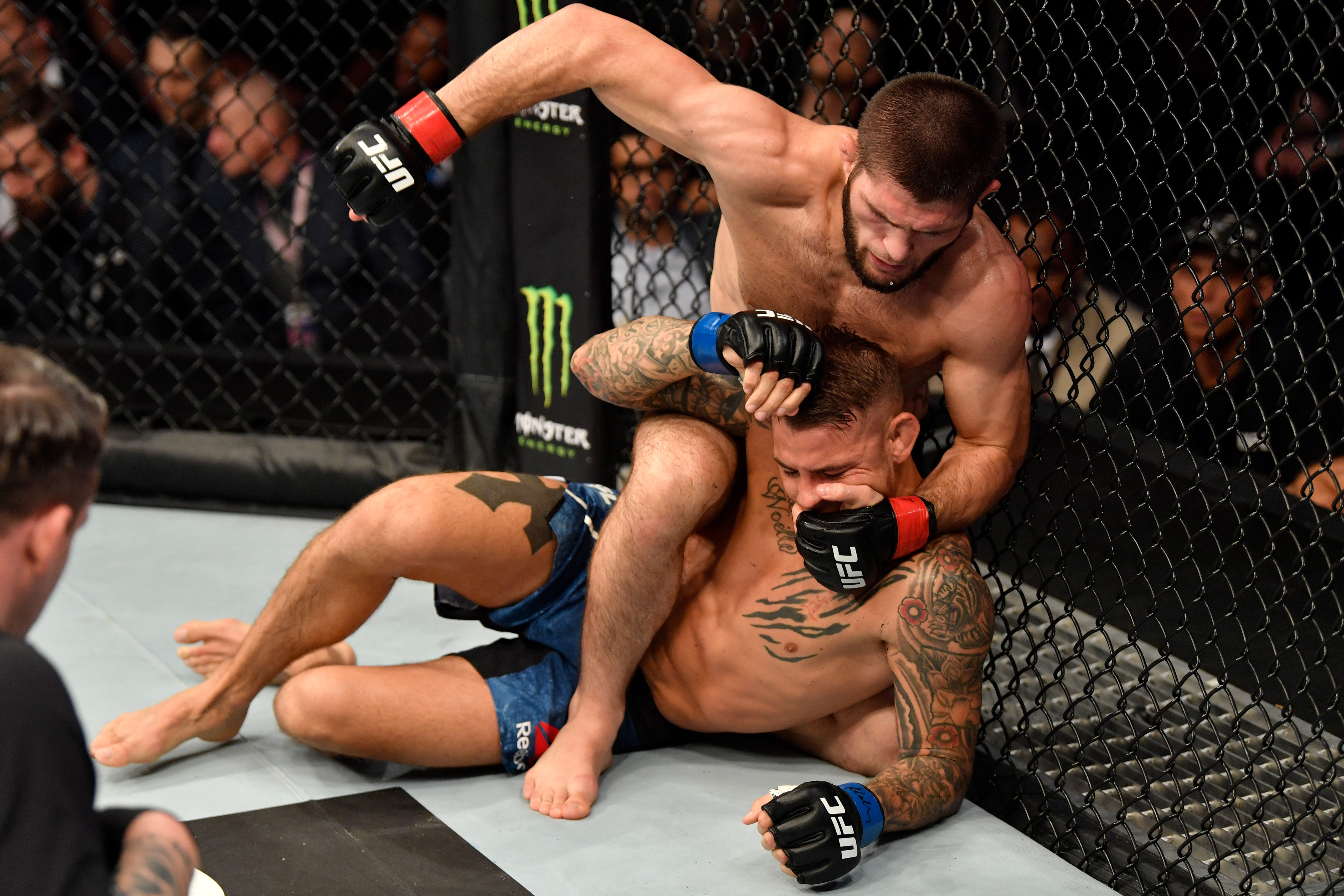 Dustin Poirier in action, showcasing his chest tattoo with the Bushido code