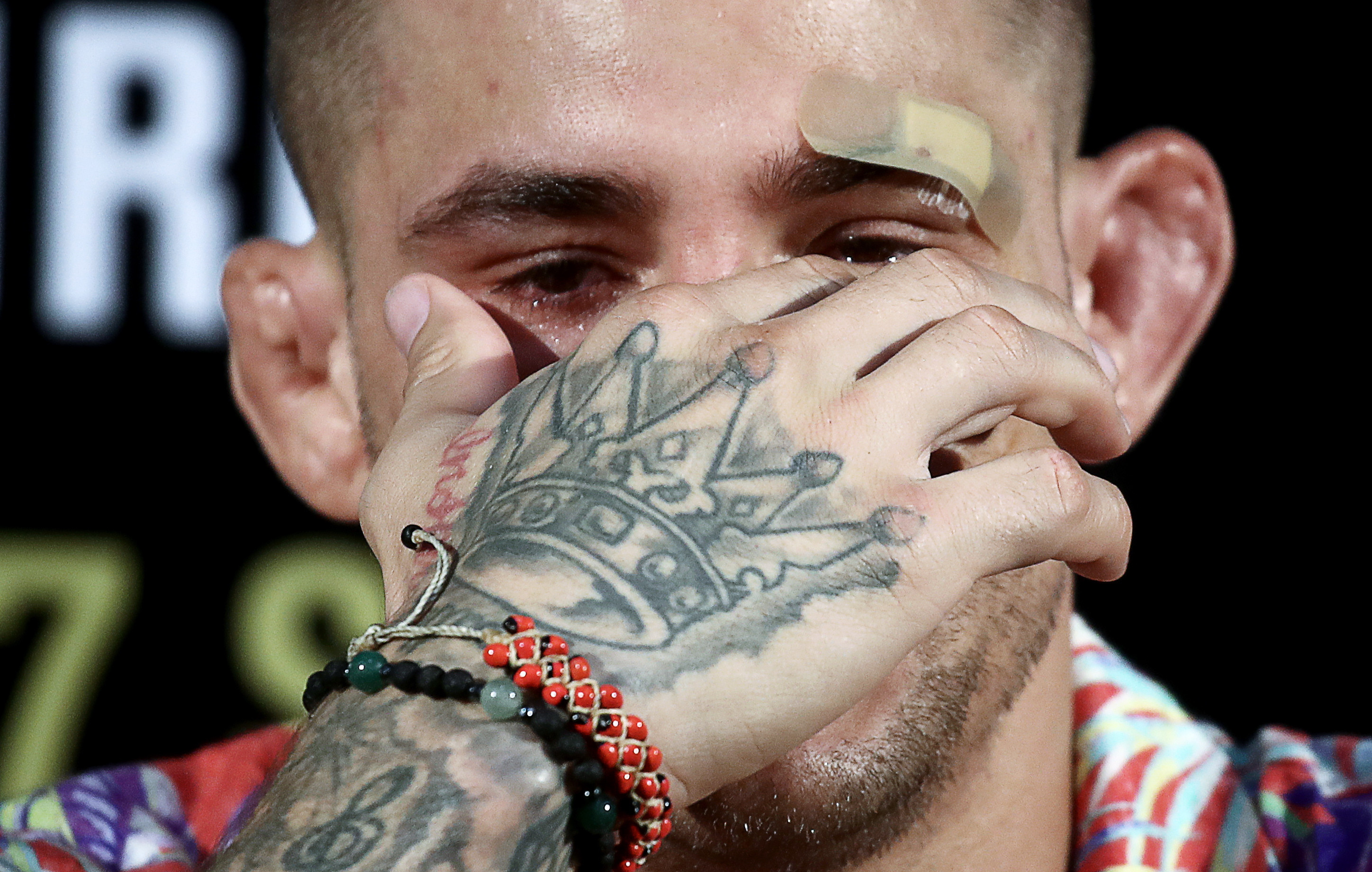 Close-up of Dustin Poirier's right hand tattoo with the word &quot;inspire&quot; and a crown