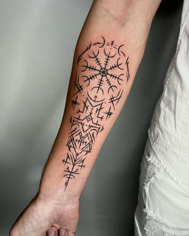 Norse sleeve tattoo featuring Norse gods, runes, and mythological creatures in a detailed style