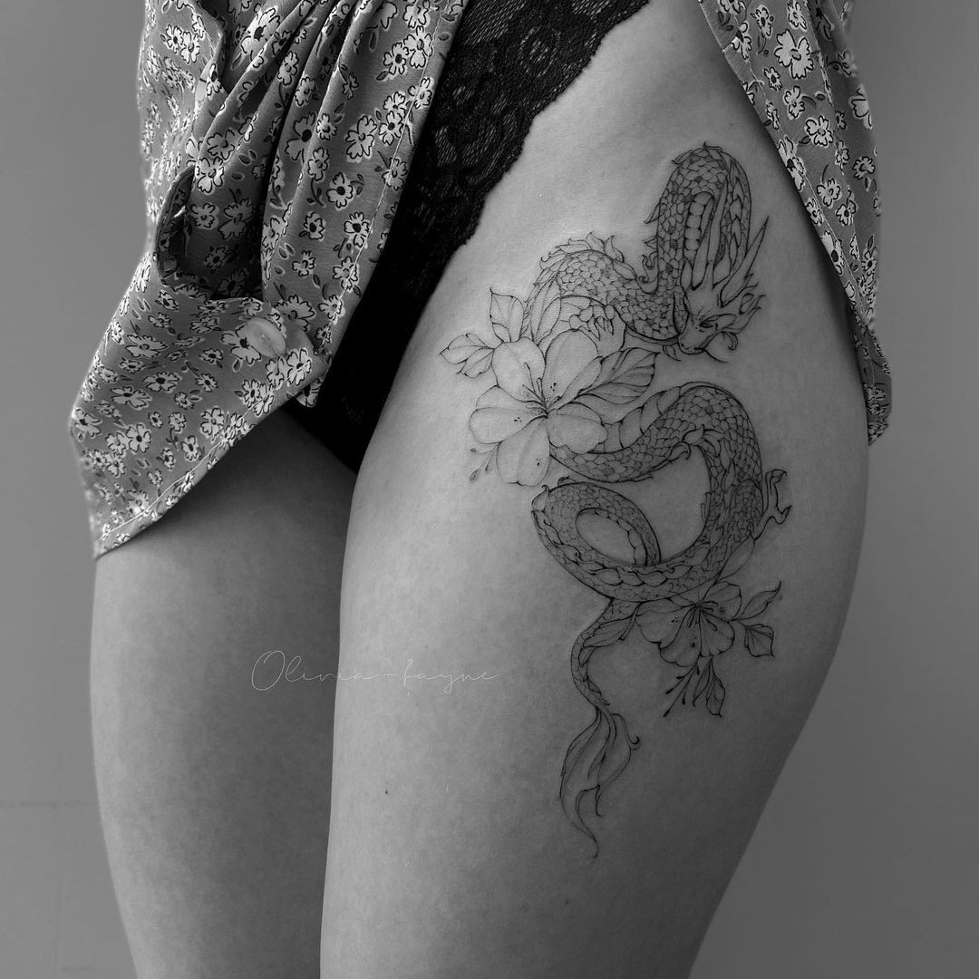 Unique sexy dragon tattoo for women, fierce design with bold thigh placement