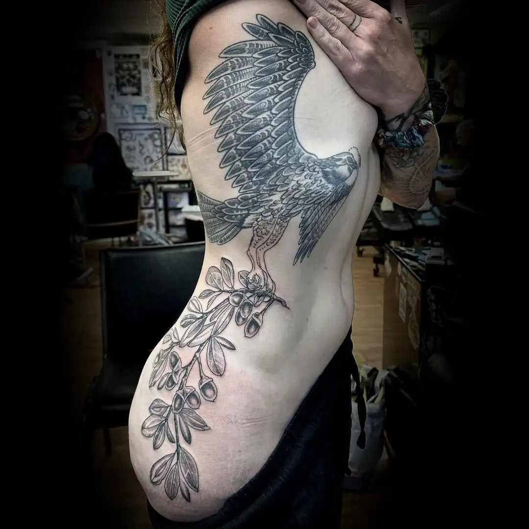 Majestic osprey bird tattoo on the side rib of a woman representing freedom