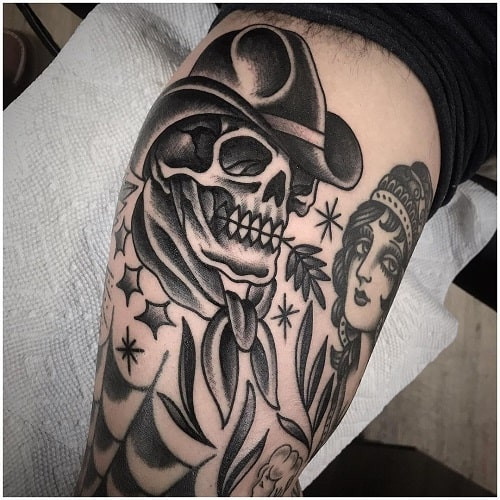 Outlaw cowboy skull tattoo with bandana and guns