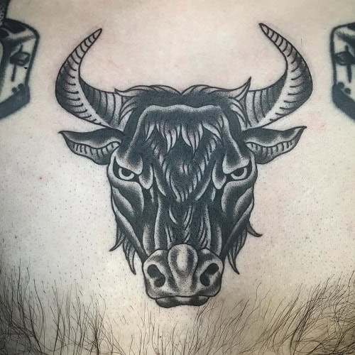 Detailed black ink ox tattoo on the upper arm