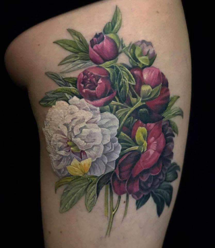 Artist inking a nature-themed tattoo at Pioneer Tattoo studio