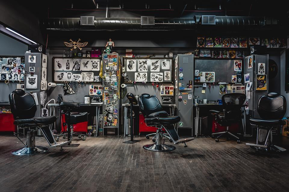 Exterior of Code Of Conduct tattoo shop under elevated train tracks