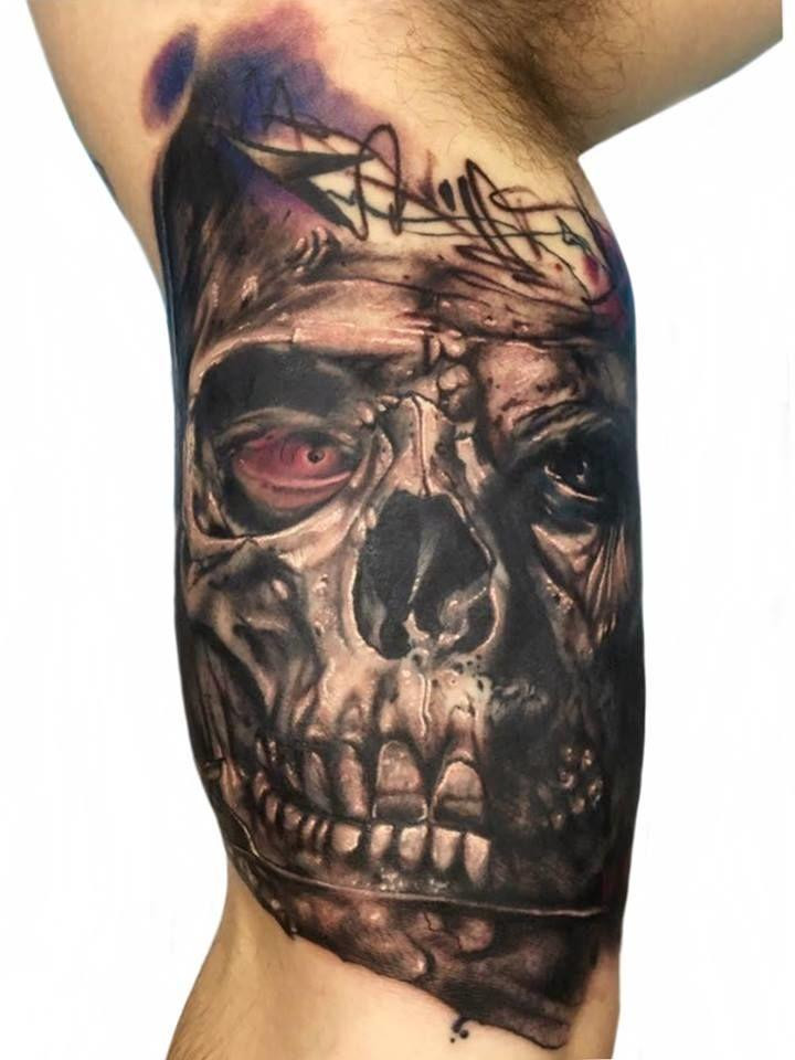 Tattoo artist working on a client at Revolution Tattoo studio