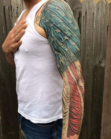 Patriot sleeve tattoo featuring the American flag, eagles, and patriotic symbols in vibrant colors