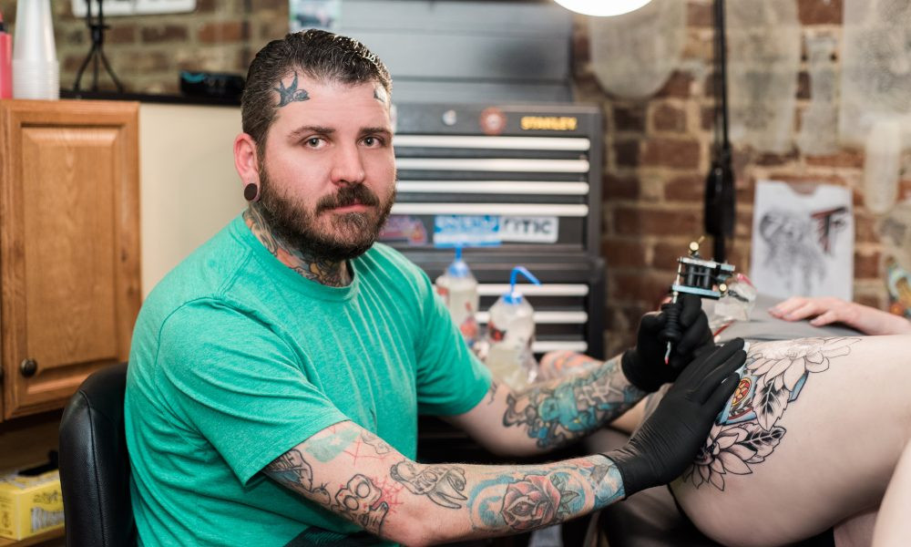 James Cooper, owner of Against All Odds Tattoo ATL, portrait in his studio