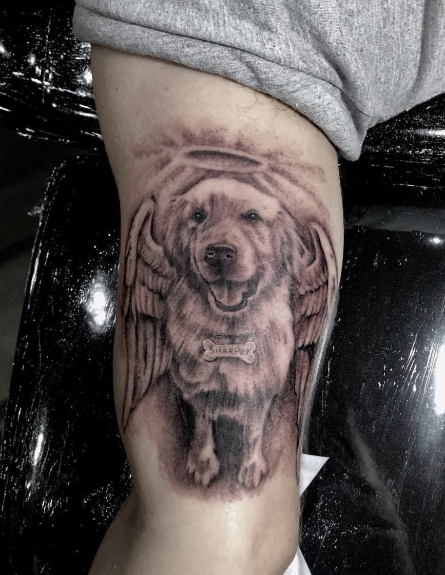 Touching pet angel tattoo, symbolizing the love and remembrance of a departed pet.