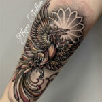 Detailed phoenix tattoo design showcasing vibrant colors and intricate feather work, symbolizing rebirth and transformation.