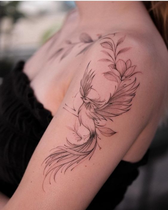 Delicate bird tattoo on woman