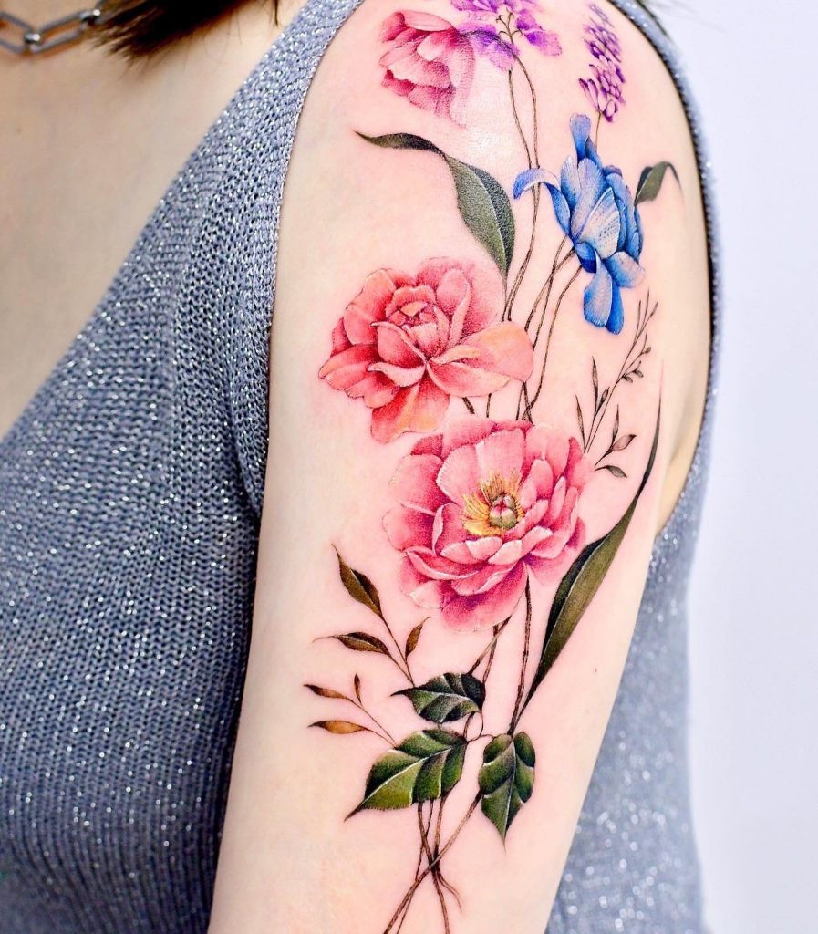 Pink floral tattoo by Yerae, highlighting the soft and feminine aesthetic she brings to floral cover-up tattoos.