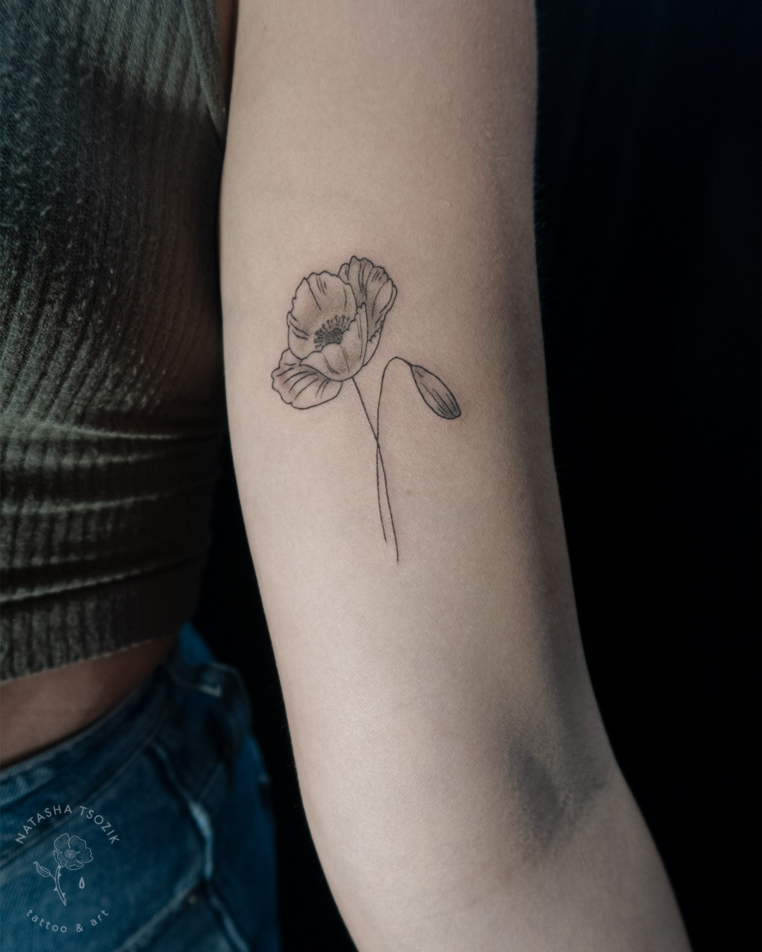 A poppy flower on a bicep