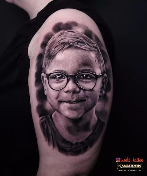 Black and gray portrait tattoo on the arm, showcasing skilled artistry in men tattoo ideas.