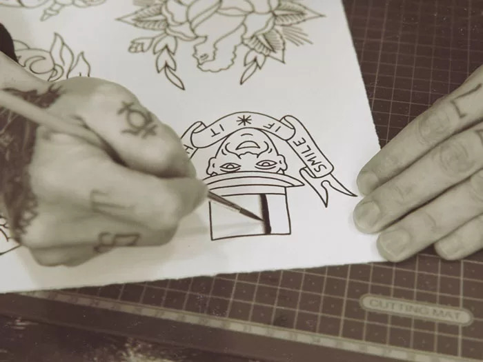 Close-up of shading tattoo flash sheet art with Indian ink and watercolor brushes