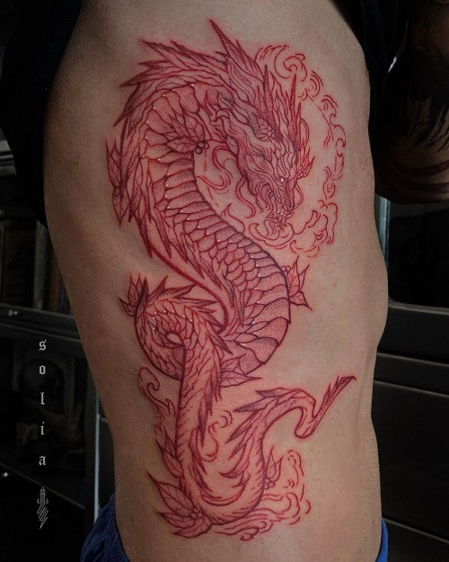 Vibrant red ink dragon tattoo on arm