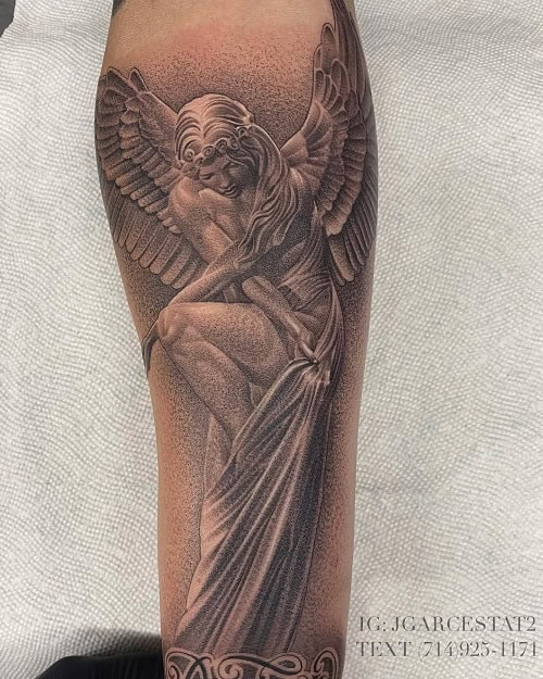 Forearm tattoo of a detailed angel in black and grey