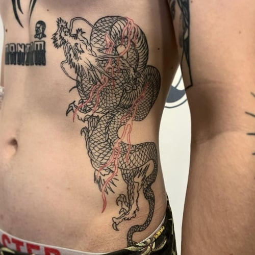 A rib tattoo with detailed linework along a man's ribs, painful yet impactful