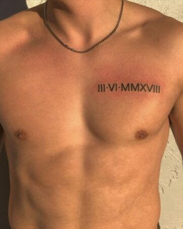 Man with a Roman numerals chest tattoo featuring a significant date in bold numerals