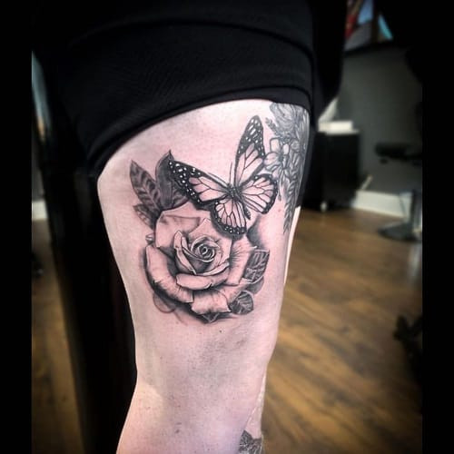 Harmonious rose and butterfly tattoo art