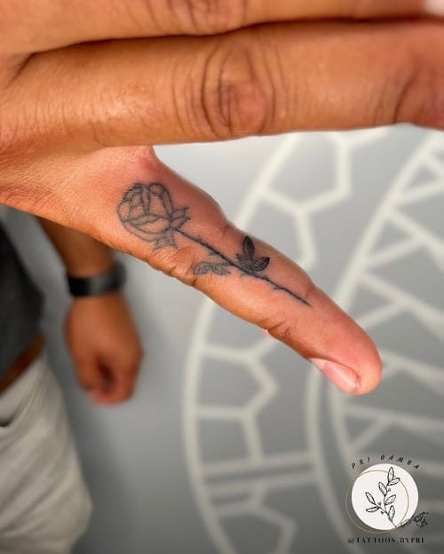 Discreet rose finger tattoo for subtle expression