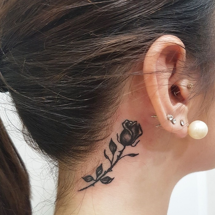 Outline style rose neck tattoo with fine lines and no shading, simple and understated.