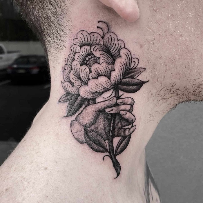 Detailed blackwork rose neck tattoo with heavy shading and intricate patterns, dark and dramatic.