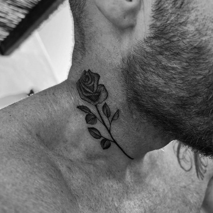 Feather and rose neck tattoo, symbolizing freedom, lightness, and delicate beauty.