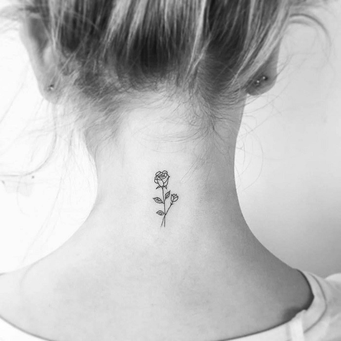 Negative space rose neck tattoo, using the absence of ink to create the rose design, unique and modern.