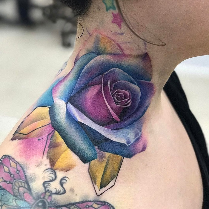 Small, minimalist black outline rose tattoo on the side of a woman's neck.