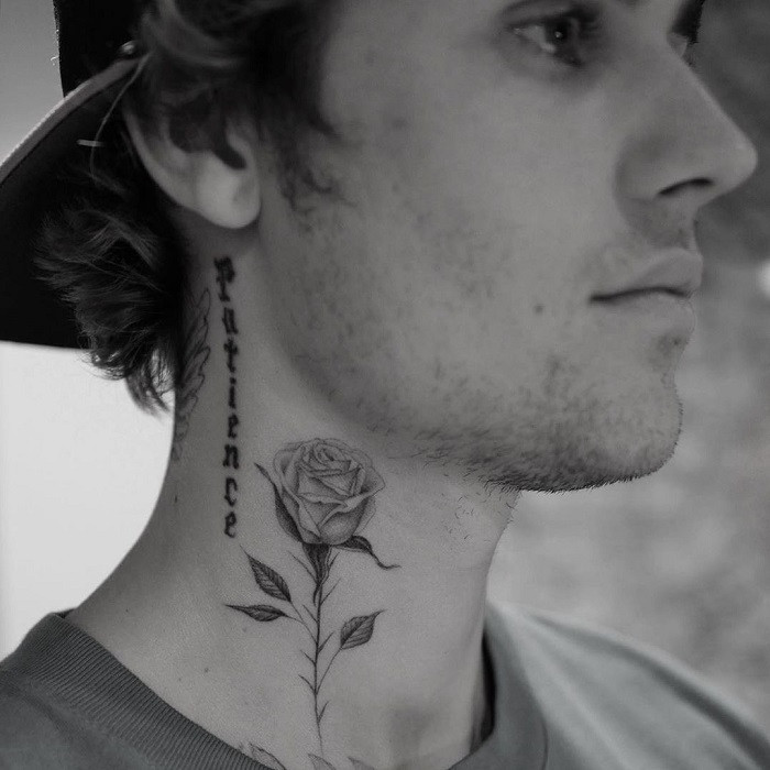 Cross and rose tattoo on the neck, blending faith and spirituality with love and sacrifice.