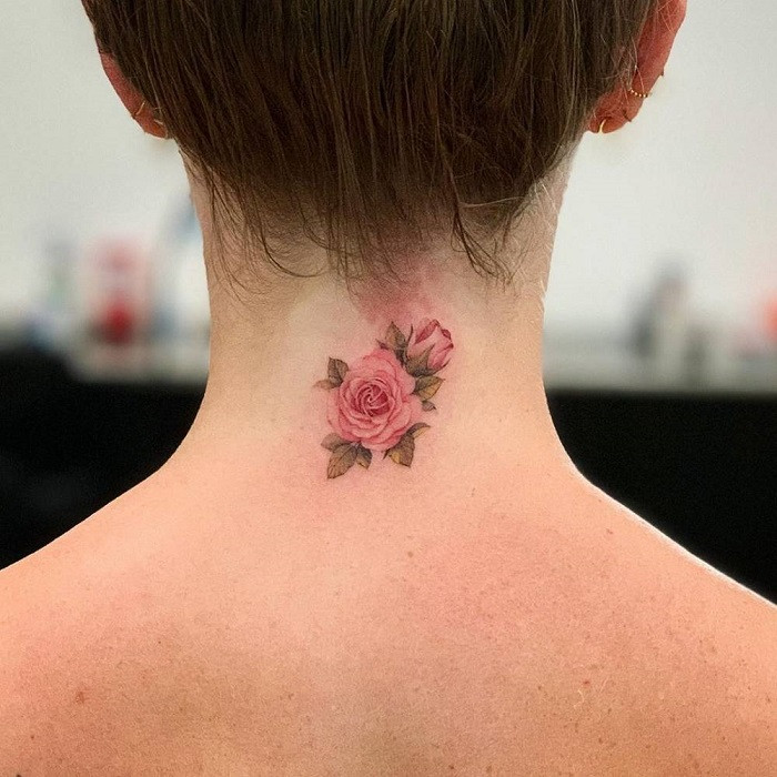 Small, delicate black line rose tattoo on the back of the neck, minimalist and subtle.