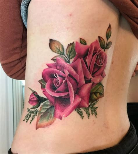 Artistic blackwork rose tattoo with intricate patterns and bold lines, creating a visually striking design.