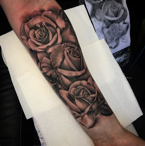 Rose tattoo ideas for men with bold lines and shading