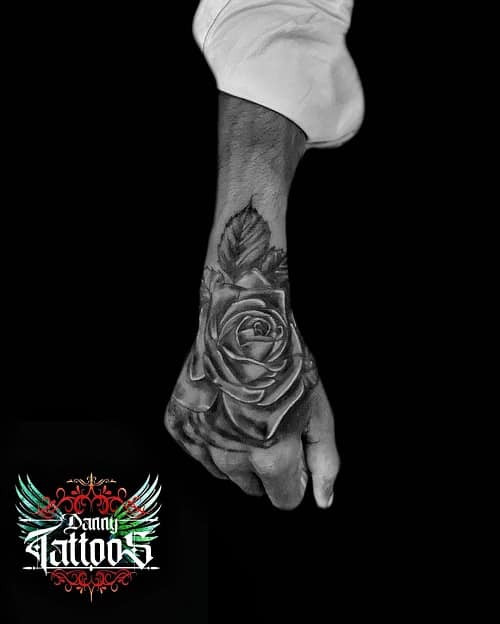 Prominent rose tattoo on hand placement