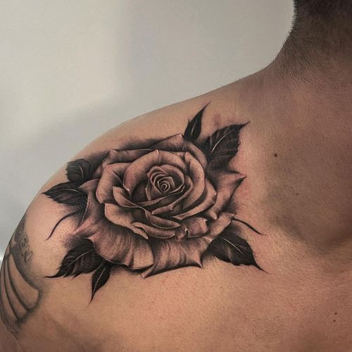 A black rose tattoo with detailed shading on a man's forearm, representing loss or depth