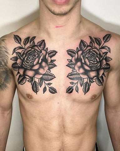 A rose bush chest tattoo with detailed roses, thorns, and leaves, symbolizing love, beauty, and resilience.