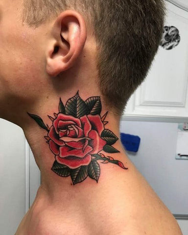 A man displaying a vibrant red rose neck tattoo, highlighting the use of color to enhance the symbolic meaning of love and passion.