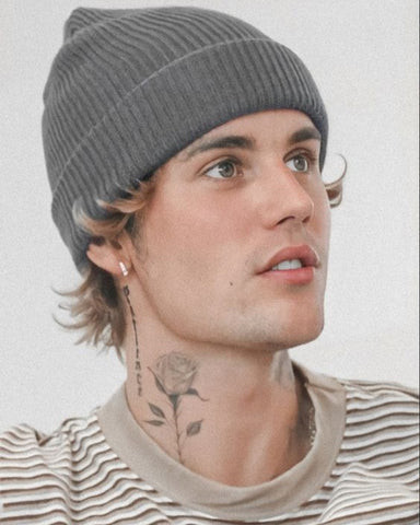 Justin Bieber showcasing a delicate rose neck tattoo